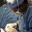 Surgeon in the operating room performing hammertoe correction surgery.