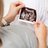 Pregnant woman looking at ultrasound abdominal scan photo of developing fetus.